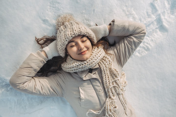 Fototapeta na wymiar Woman Lying on the Snow