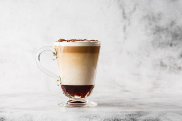 Coffee with Irish whiskey and whipped cream in glass isolated on bright marble background. Overhead view, copy space. Advertising for cafe menu. Coffee shop menu. Horizontal photo.