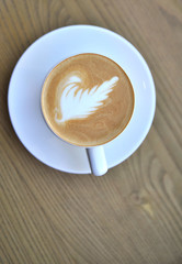Cup of coffee on wooden background.