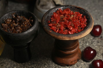 bowl with tobacco for hookah. passion fruit on a dark background. smoking shisha
