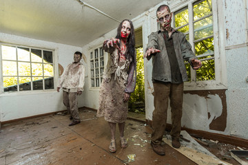 Obraz na płótnie Canvas Zombies come into an abandoned house