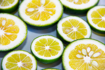 round slices of natural fresh yellow lemon in a green peel