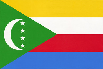 Comores island national fabric flag, textile background. Symbol of international world African...