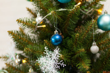 Obraz na płótnie Canvas Beautiful green Christmas tree decorated with balls and garlands. Close-up photo