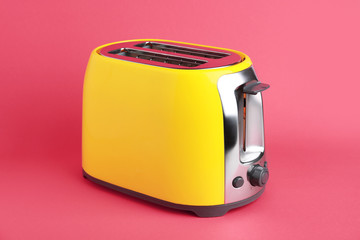 Modern toaster on color background