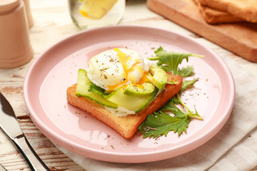 Plate with tasty sandwich on table