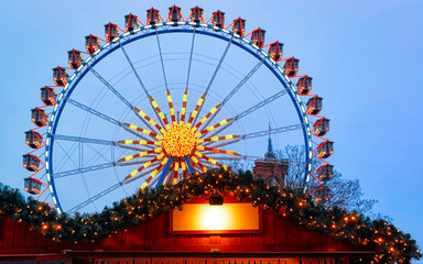 Ferris Wheel of Night Christmas Market at Town Hall Winter Berlin, Germany. German street Xmas and holiday fair in European city or town. Advent Decoration and Stalls with Crafts Items on Bazaar