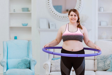The model is a fat woman, trying to lose weight at home and doing exercises with halajup