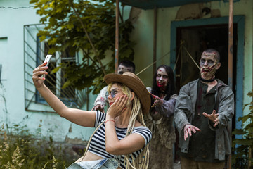 Selfie on a background of zombies, zombies tied to an abandoned house