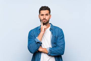 Handsome man over isolated blue background Looking front