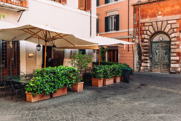 Cozy old street in Trastevere in Rome, Italy. Trastevere is rione of Rome, on west bank of Tiber in Rome. Architecture and landmark of Rome