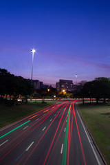 Traces of red lights and a taxicab green light in an express avenue in Rio de Janeiro during twilight