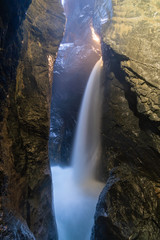 Long exposure of a hidden waterfall – waterfall in between massive rocks.