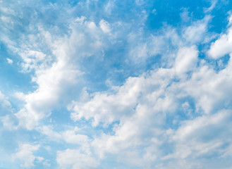 Blue sky and beautiful white clouds. Bright sunny day. Background with copy space