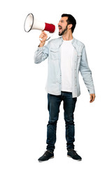 Full-length shot of Handsome man with beard shouting through a megaphone over isolated white background