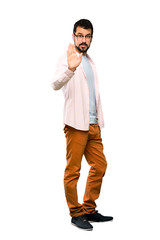 Fototapeta premium Full-length shot of Handsome man with beard making stop gesture over isolated white background