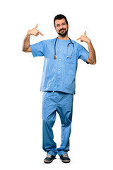 Full-length shot of Surgeon doctor man proud and self-satisfied over isolated white background