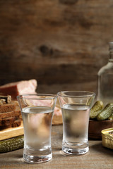 Obraz na płótnie Canvas Cold Russian vodka with snacks on wooden table