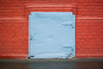 Blue door in a red brick wall.