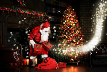 Christmas night, Santa Claus puts gifts under the tree