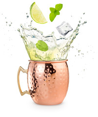 lime, mint and ice cube falling into a splashing moscow mule cocktail isolated on white