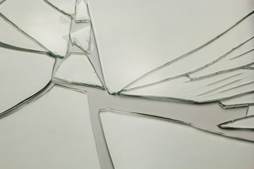 Broken glass background for your images isolated on white. Many large fragments of crumbled.