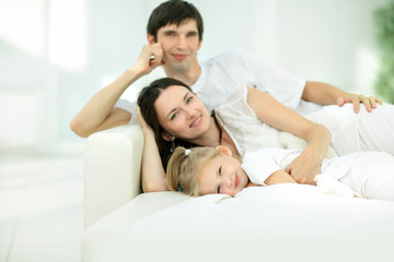 Obraz na płótnie Canvas happy family lying on the sofa on Sunday.