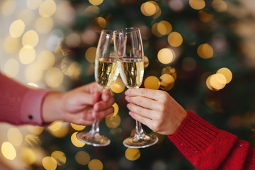 Man and woman hands with full champagne glasses