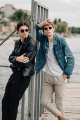 Two Stylish Twins Brothers Posing on the Pier Near the River