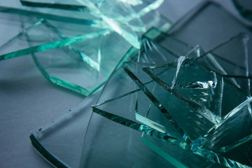 Broken glass background for your images isolated on white. Many large glass fragments scattering from a hammer as a concept of violence.