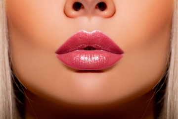 Close-up Beautiful lips.  Lip Gloss. Part of face, young woman close up. Sexy plump lips mother of...