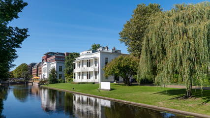 Obraz premium the Hague canal with houses, green trees on a sunny day, netherlands