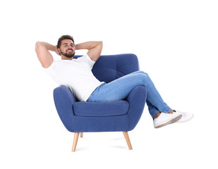 Young man resting in armchair isolated on white