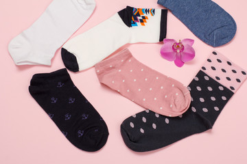 Color women socks on a pink background.