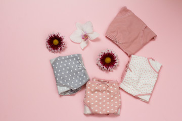 Beautiful women's cotton panties on pink background with flower buds.