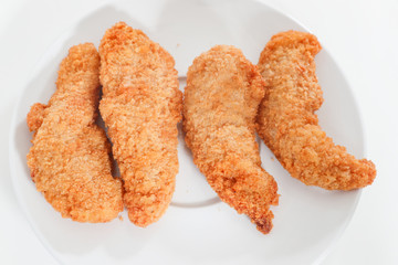 Delicious crispy fried breaded chicken breast strips . - Image
