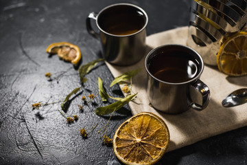 Fototapeta na wymiar cup of healthy lemon tea with croissants and citruses