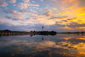 Panorama beautiful Sunset with dramatic sky clouds.Sunrise with cloud reflection in water at Koh Klang nam , public park in Sisaket Thailand,ASIA.