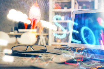 Multi exposure of table with computer and seo drawing hologram. Search optimization concept.