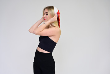 Fototapeta premium New Year celebration concept with beautiful girl. Portrait of a fashionable beautiful blonde model with long hair, great makeup, on a white background.