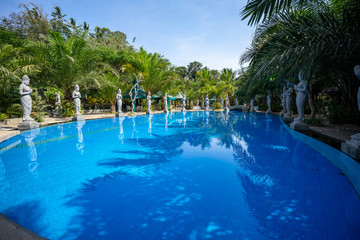 Blue pool beside green garden