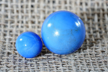Colorful glass balls photographed in studio on jute pad with macro