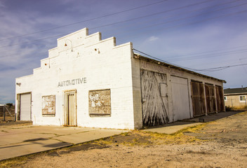 Fototapeta na wymiar Old Abandoned Garage Building With Boarded Up Windows