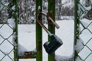 Open padlock on the old fence.