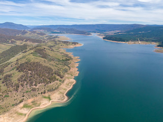 Naklejka premium High angle aerial drone view of Blowering Reservoir (dam) near Tumut in the Snowy Mountains region of New South Wales, Australia. Notice the low water levels due to ongoing drought in Australia.