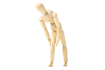 Wooden figure having pain in knee on white background
