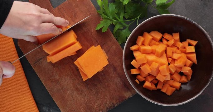 Slicing a piece of butternut squash
