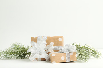 Gift boxes with fir tree branches on white background
