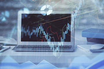 Forex market chart hologram and personal computer background. Multi exposure. Concept of investment.