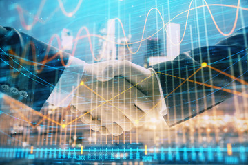 Double exposure of financial chart on cityscape background with two businessmen handshake. Concept of financial analysis and investment opportunities